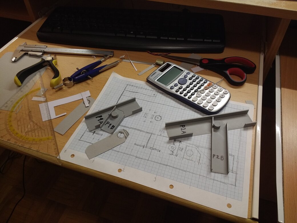 A desk full of tools, plans and prototypes